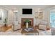 Comfortable living room featuring a brick fireplace, built-in shelves, and modern decor at 516 Amanda Dr, Weddington, NC 28104