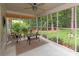 Screened porch with outdoor seating, ceiling fan, and views of landscaped backyard at 516 Amanda Dr, Weddington, NC 28104