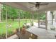 Screened porch with outdoor seating and a view of a lush backyard at 516 Amanda Dr, Weddington, NC 28104