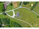 Stunning aerial view of this home on a large, well-maintained lot with long driveway access at 5606 S Rocky River Rd, Monroe, NC 28112