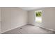 Cozy bedroom featuring neutral walls, carpet flooring, and a window with green views at 5606 S Rocky River Rd, Monroe, NC 28112