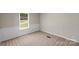 Bedroom featuring neutral walls, carpet flooring, and a window with green views at 5606 S Rocky River Rd, Monroe, NC 28112