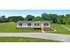 Charming single-story home featuring fresh exterior paint, and a cute wooden deck at 5606 S Rocky River Rd, Monroe, NC 28112