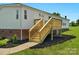 Freshly built wooden front porch, new siding, and landscaping enhance this lovely home's curb appeal at 5606 S Rocky River Rd, Monroe, NC 28112