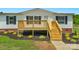 The exterior features a new wooden porch, siding, and fresh landscaping at 5606 S Rocky River Rd, Monroe, NC 28112