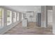 Bright, open kitchen with white cabinets, stainless steel appliances and an island offering space for cooking and entertaining at 5606 S Rocky River Rd, Monroe, NC 28112