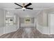 A bright, open-concept living room, has beautiful new flooring and fresh paint at 5606 S Rocky River Rd, Monroe, NC 28112