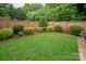 Well-maintained backyard featuring a green lawn, privacy fence, and manicured landscaping at 5917 Bridger Ct, Charlotte, NC 28211