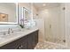 Modern bathroom featuring dual sinks, illuminated mirrors, and a glass-enclosed shower with patterned tile accents at 5917 Bridger Ct, Charlotte, NC 28211