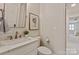 Stylish half-bathroom featuring a modern vanity with marble countertop and neutral decor at 5917 Bridger Ct, Charlotte, NC 28211