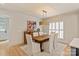 Inviting dining room with modern lighting fixture, wooden table, and seating for six at 5917 Bridger Ct, Charlotte, NC 28211