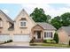 Charming home with stone porch, manicured lawn, two car garage, and well-maintained landscaping at 5917 Bridger Ct, Charlotte, NC 28211