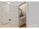 Elegant half bathroom features stylish wallpaper, a decorative mirror, and modern fixtures at 5917 Bridger Ct, Charlotte, NC 28211