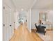 Bright hallway leads to the living area, featuring hardwood floors and elegant decor at 5917 Bridger Ct, Charlotte, NC 28211