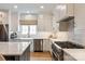 Modern kitchen features stainless steel appliances, white cabinets, and a large island at 5917 Bridger Ct, Charlotte, NC 28211