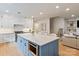 Open-concept kitchen with island, stainless appliances, and adjacent living area for modern living at 5917 Bridger Ct, Charlotte, NC 28211