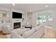 Cozy living room with fireplace, built-in shelving, and large windows for natural light at 5917 Bridger Ct, Charlotte, NC 28211