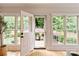 Sunroom featuring multiple windows and a door leading to a patio with a dining set at 5917 Bridger Ct, Charlotte, NC 28211