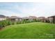 Large green backyard with well-maintained lawn, fence, and multiple houses at 602 Compass Dr, Denver, NC 28037
