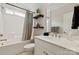 Neutral bathroom featuring a shower-tub combo with curtain rod, and single sink vanity at 602 Compass Dr, Denver, NC 28037