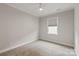 This bedroom features neutral carpet, white trim and baseboards, and a single window at 602 Compass Dr, Denver, NC 28037