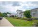 Exterior view of the community clubhouse featuring manicured landscaping and well-maintained greenery at 602 Compass Dr, Denver, NC 28037