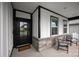 Cozy front porch with stone accents, seating, and a welcoming entrance to the home at 602 Compass Dr, Denver, NC 28037