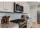 Well-equipped kitchen with modern appliances, granite countertops, and tile backsplash at 602 Compass Dr, Denver, NC 28037