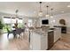 Bright, open-concept living room with island, stainless steel appliances, and modern lighting fixtures at 602 Compass Dr, Denver, NC 28037