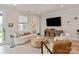 Bright living room with modern decor, a curved sofa, and a media center at 602 Compass Dr, Denver, NC 28037