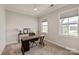 Bedroom featuring a ceiling fan, large windows, and a wooden desk at 602 Compass Dr, Denver, NC 28037