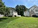 Exterior view of a home with a well-maintained lawn and white picket fence at 6120 Brightstar Valley Rd, Mint Hill, NC 28227