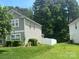 Home exterior with a large yard and lush green trees at 6120 Brightstar Valley Rd, Mint Hill, NC 28227