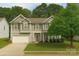 Charming two-story home with a well-manicured lawn and attached two-car garage at 6120 Brightstar Valley Rd, Mint Hill, NC 28227