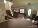 Inviting living room with carpet, staircase, front door and comfortable furnishings at 6120 Brightstar Valley Rd, Mint Hill, NC 28227