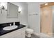 Bathroom featuring a single sink vanity with a dark countertop, toilet, and shower with sliding door at 6626 Rocky Falls Rd, Charlotte, NC 28211
