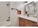 Modern bathroom features subway tile in the shower, stylish mirror, and wood vanity at 6626 Rocky Falls Rd, Charlotte, NC 28211