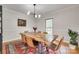 Charming dining room with modern chandelier and a rustic wooden table at 6626 Rocky Falls Rd, Charlotte, NC 28211