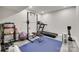 Home exercise room features a treadmill, weight rack, rowing machine, kettle bells, exercise ball, and blue mat at 6626 Rocky Falls Rd, Charlotte, NC 28211