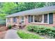 Stylish brick home featuring updated windows, a well-manicured lawn, and inviting front entrance at 6626 Rocky Falls Rd, Charlotte, NC 28211