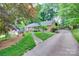 Charming brick home with lush landscaping, long driveway, and beautiful curb appeal at 6626 Rocky Falls Rd, Charlotte, NC 28211