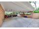 Spacious, covered garage with brick walls, storage space, and a concrete floor at 6626 Rocky Falls Rd, Charlotte, NC 28211