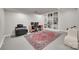Home office with a desk, chair, two monitors, built-in bookcase, white armchair and oriental rug at 6626 Rocky Falls Rd, Charlotte, NC 28211