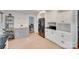 Functional kitchen with white cabinets, black appliances, and an adjacent dining area at 6626 Rocky Falls Rd, Charlotte, NC 28211