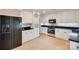 Bright kitchen featuring white cabinetry, black appliances, and ample countertop space at 6626 Rocky Falls Rd, Charlotte, NC 28211