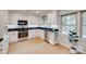 Classic kitchen with white cabinets, black countertops, and stainless steel appliances at 6626 Rocky Falls Rd, Charlotte, NC 28211