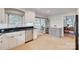 Bright kitchen features white cabinetry, black countertops, and stainless steel appliances overlooking a window at 6626 Rocky Falls Rd, Charlotte, NC 28211