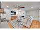 Spacious living room with hardwood floors, a ceiling fan, and a comfortable sectional sofa at 6626 Rocky Falls Rd, Charlotte, NC 28211