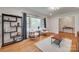 Bright living room featuring hardwood floors, large windows, and neutral paint at 6626 Rocky Falls Rd, Charlotte, NC 28211