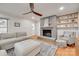 Cozy living room with a brick fireplace, hardwood floors, and a comfortable seating arrangement at 6626 Rocky Falls Rd, Charlotte, NC 28211